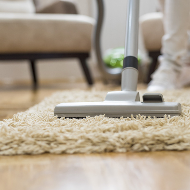 Professional carpet vacuuming during residential cleaning service